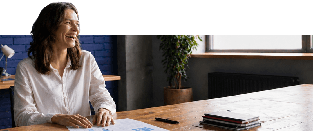 Female smiling laughing hands on paper over working table Female smiling laughing hands on paper over working table