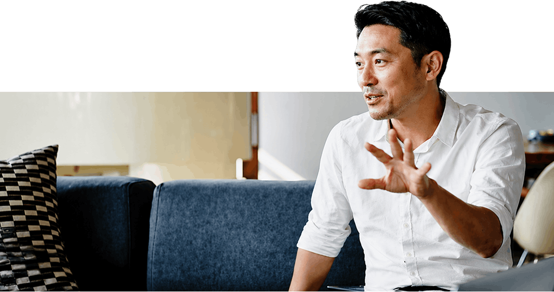 Man in white shirt talking sitting on sofa Man in white shirt talking sitting on sofa