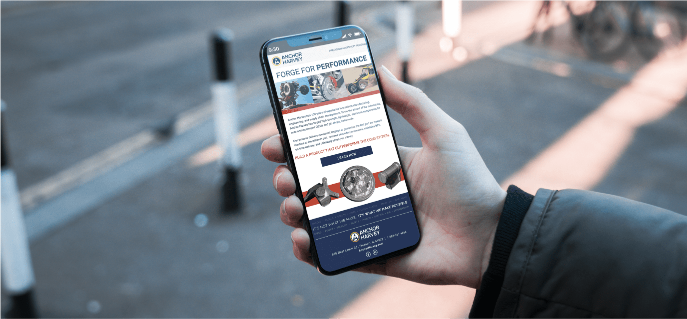 Hand holding a cell phone that shows the Anchor Harvey mobile site