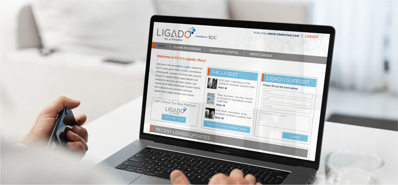 Hands using a laptop that shows the Ligado website