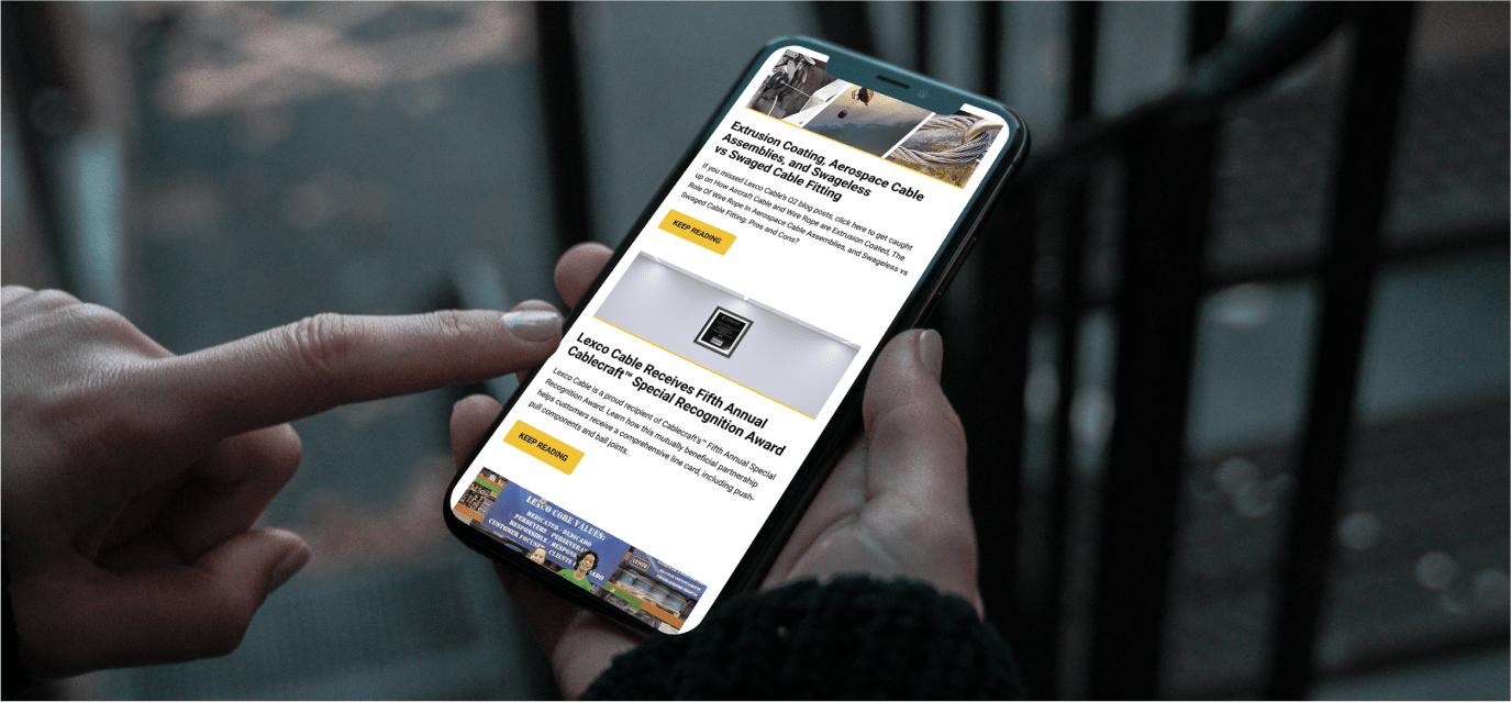 Hands using a mobile phone, which displays the Lexco website