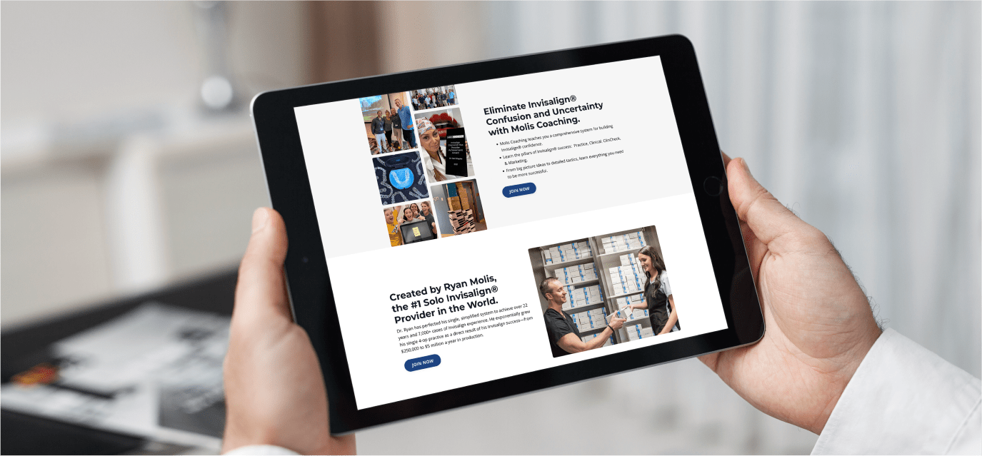 Hands holding a tablet showing the website for Molis Coaching