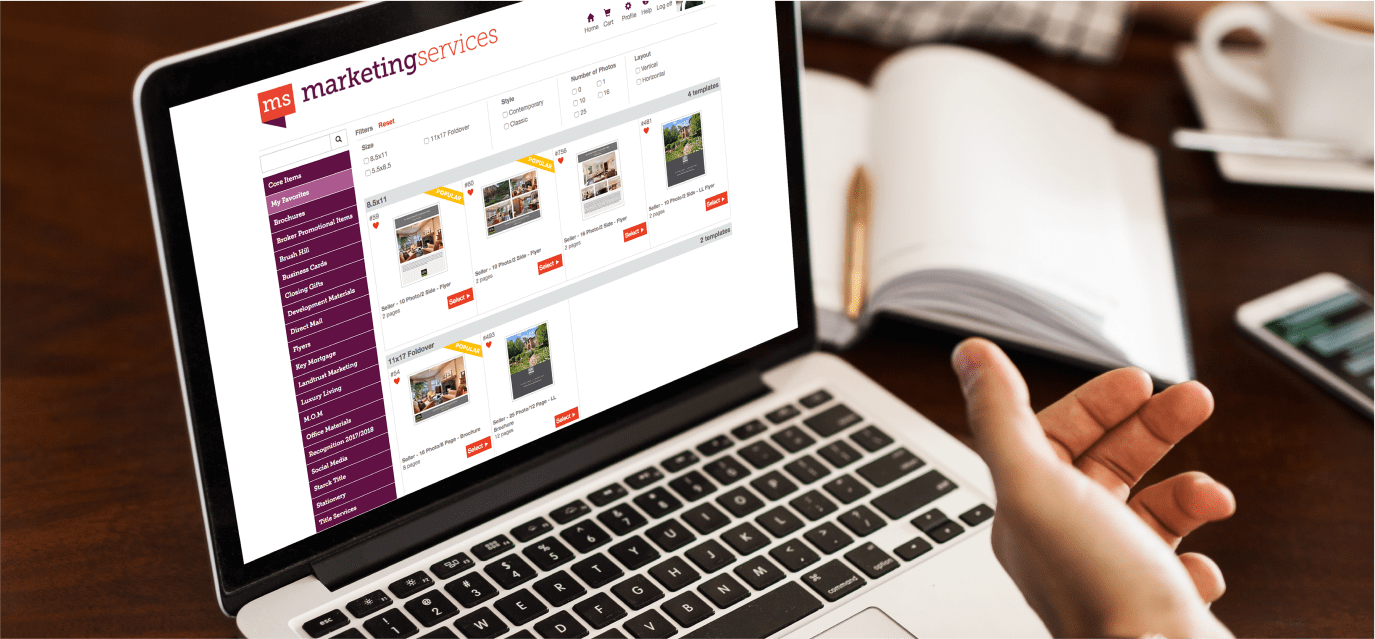 Hand pointing to a laptop on a desk, laptop screen showing the website of MS Marketing Services