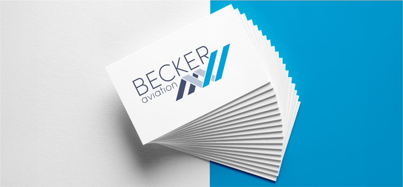 Stack of business cards for Becker Aviation against a white and blue background