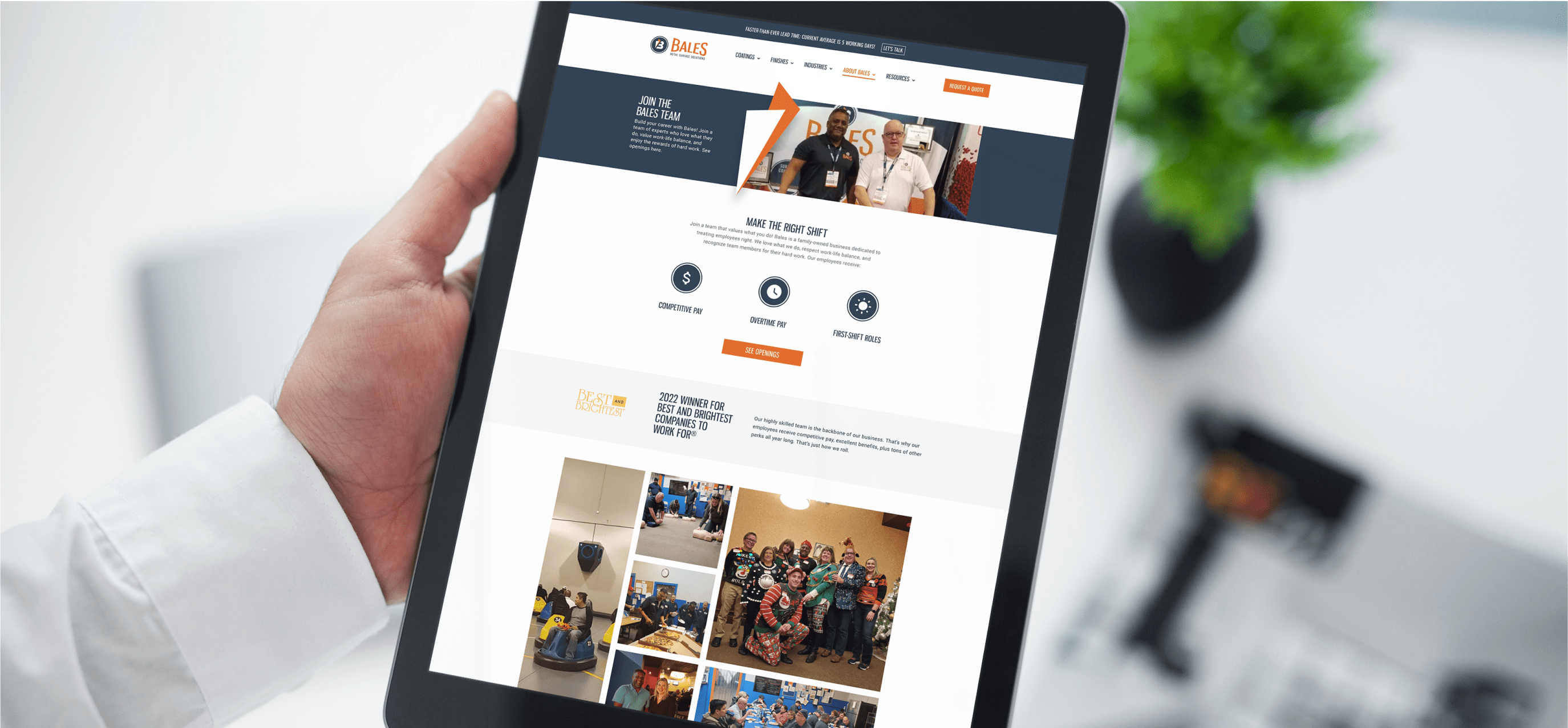 Hand holding a tablet that shows the Bales Metal Surface Solutions website