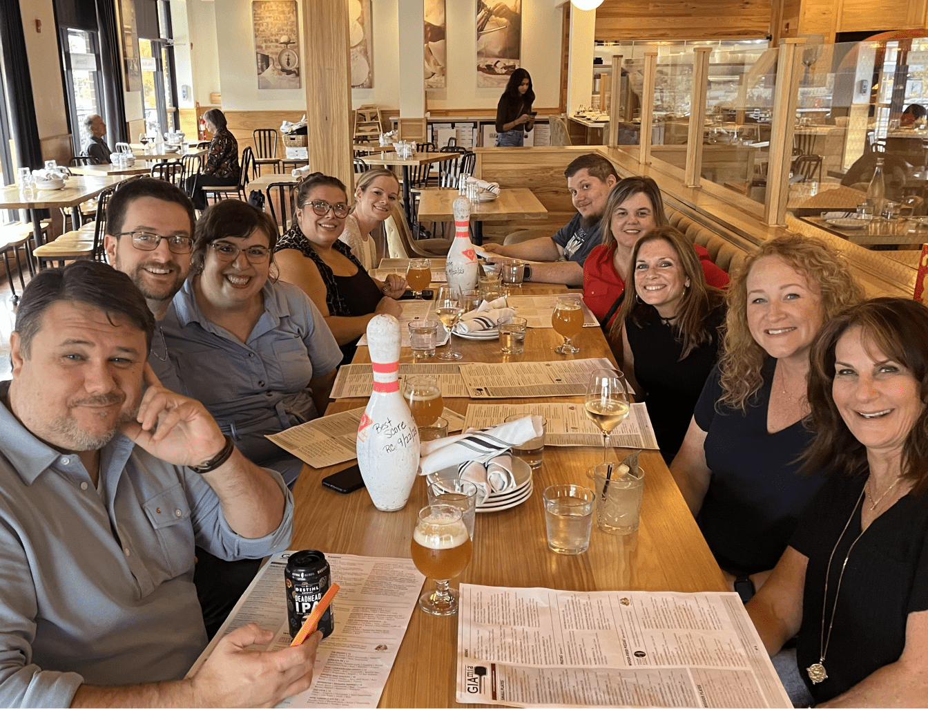 Red Caffeine team at a restaurant table, smiling