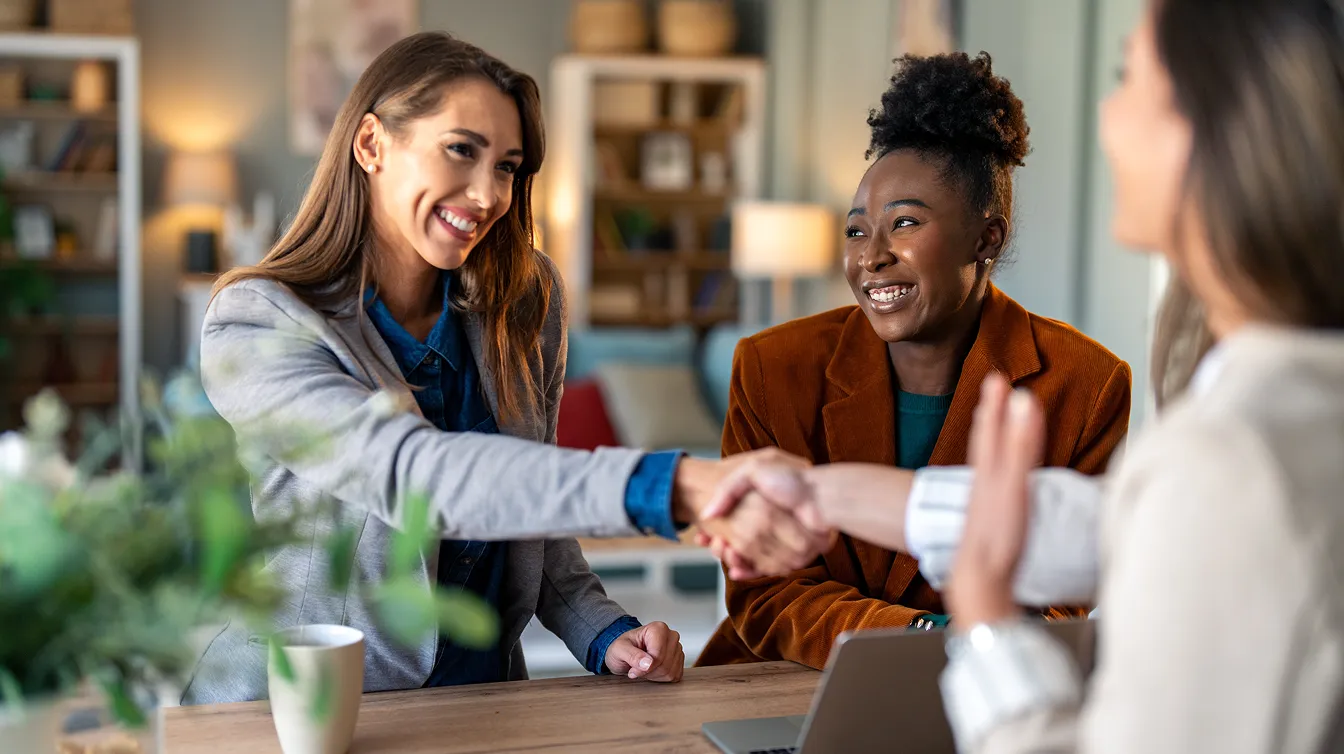 two female shaking hands